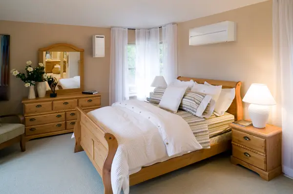 Calm bedroom with a discreet wall-mounted air conditioning unit